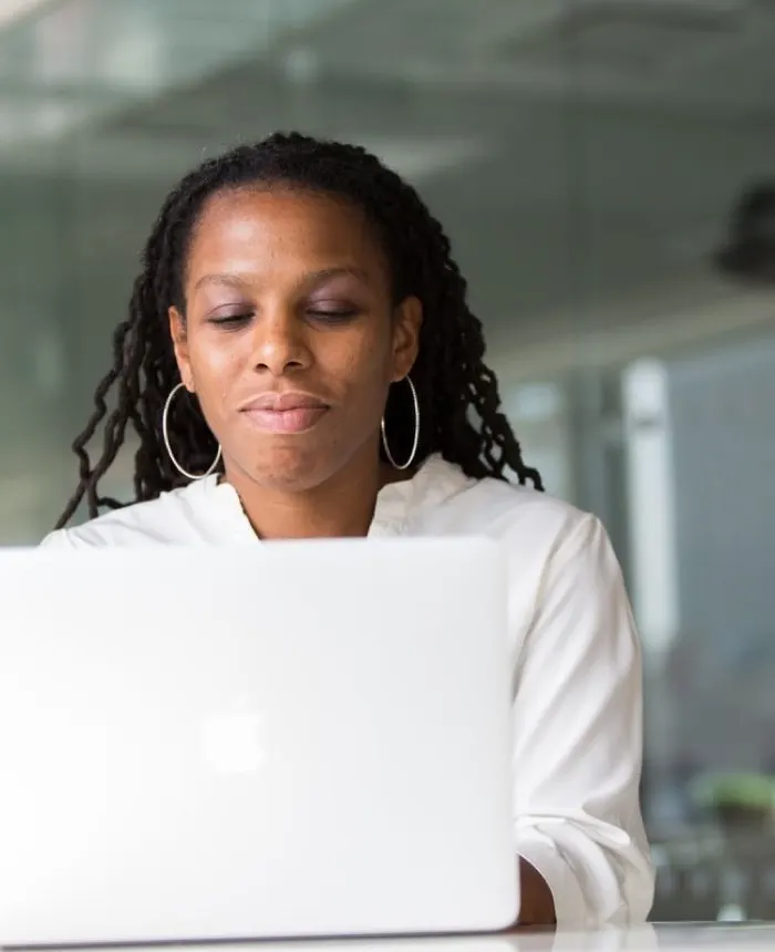 SmartTech Solutions team member reviewing product progress on a laptop