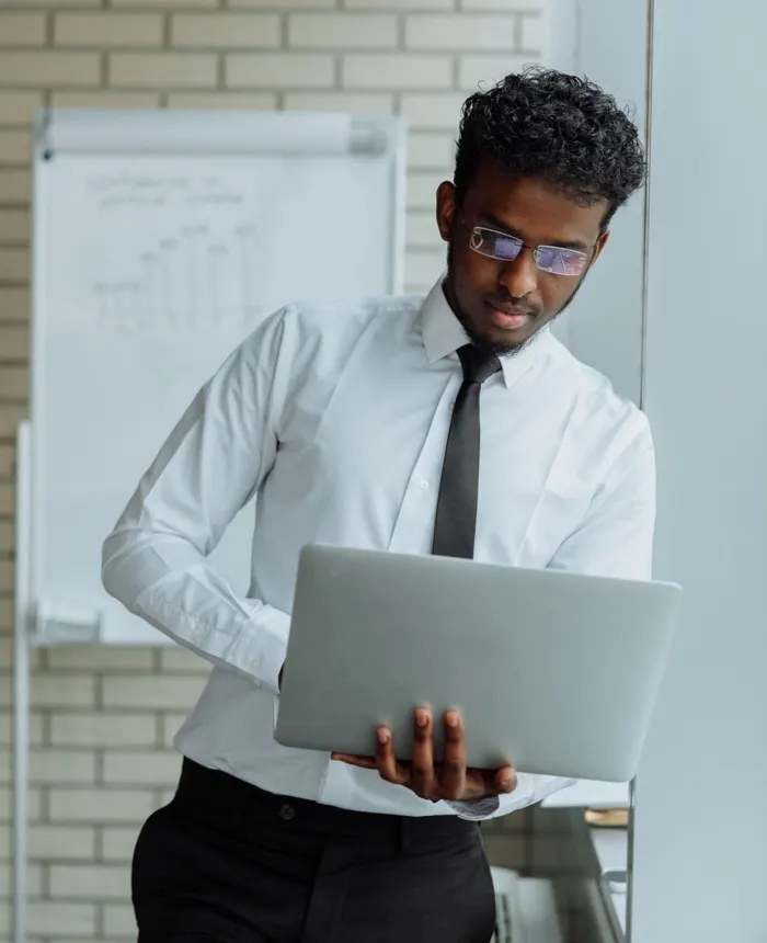A SmartTech web developer reviewing a client build on a laptop